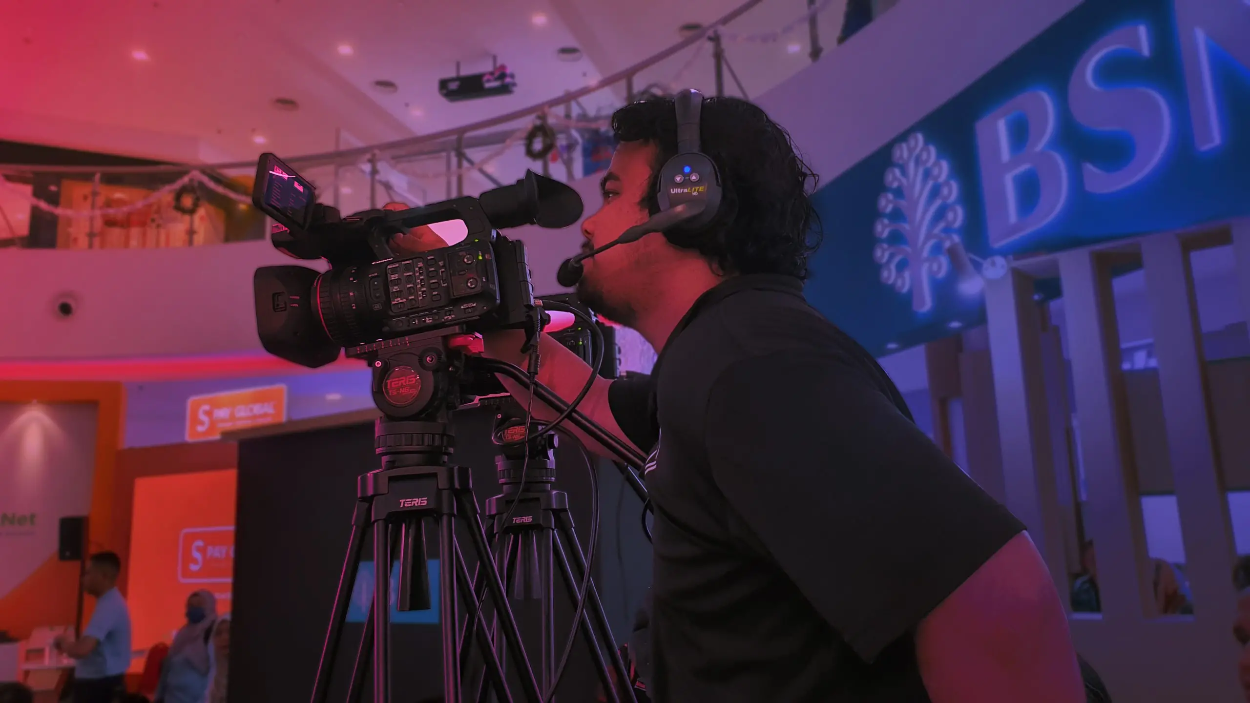 Camera crew setting up equipment for a live event.