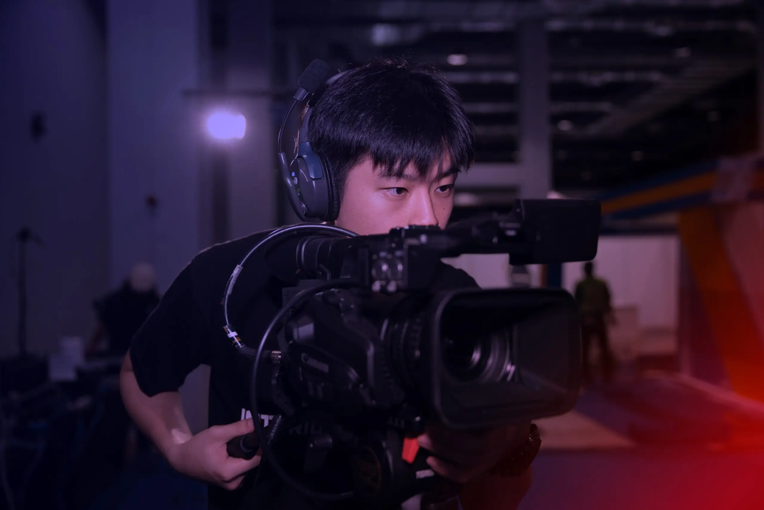 Camera operator monitoring a live event feed in Penang.