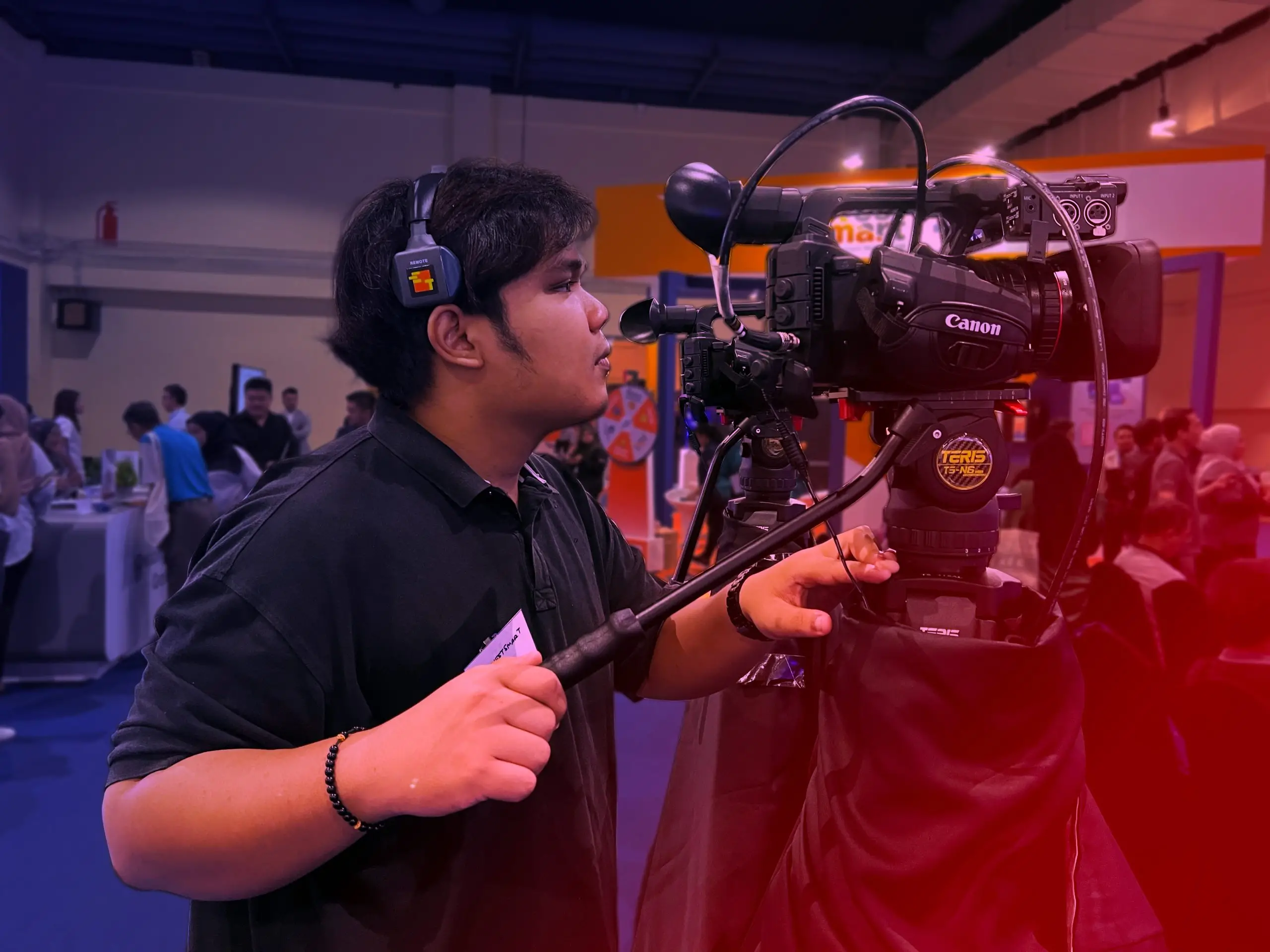 Camera crew setting up equipment for a live event.